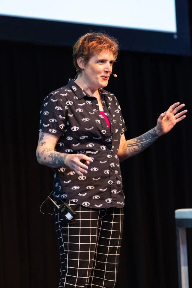 Miriam on stage at CSS Day 2023, wearing various black and white patterns
