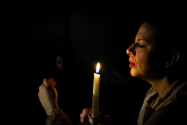 Close up, Jane blows out a candle.
