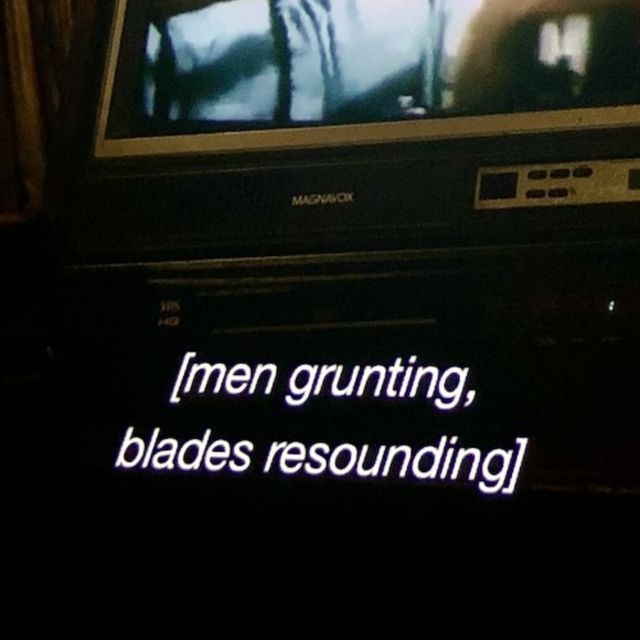 [men grunting, blades resounding] caption from a tv or movie still